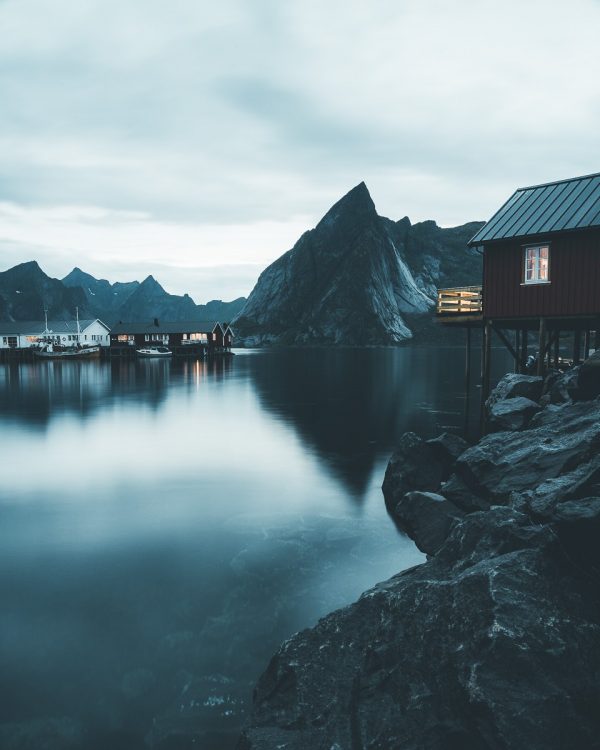 Eliassens-roburer-night-water-reflections-red-cabins-lofoten-norway